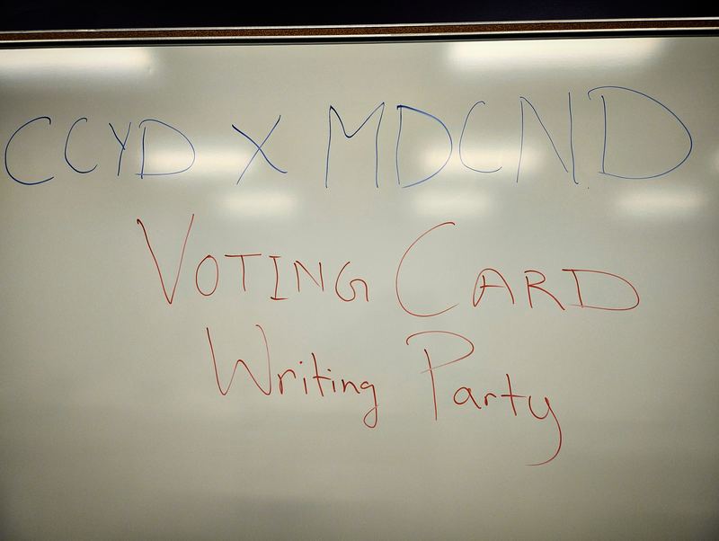 Whiteboard reading "CCYD x MDCND Voting Card Writing Party"